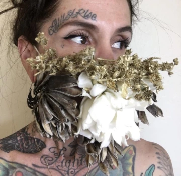 Women wearing a face mask of dried flowers