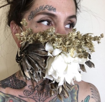 Women wearing a face mask of dried flowers