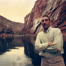 stewart udall standing near water in a canyon