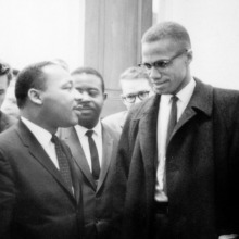 Photo of Martin Luther King, Jr. and Malcolm X waiting for press conference