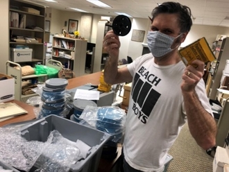 trent purdy holding up preserved films in both hands