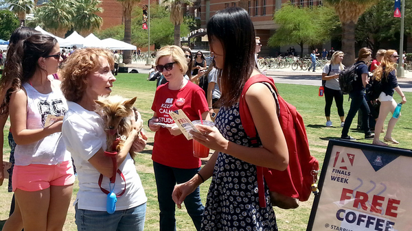 Library volunteers and students on the UA mall with therapy dog