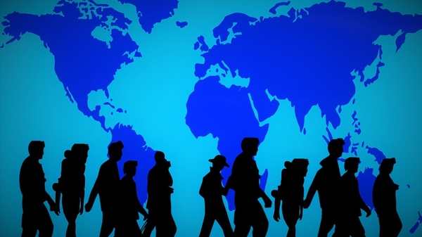 shadows of people walking across a global map