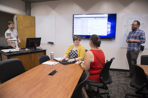 Faculty members using technology in the Collaborative Faculty Room