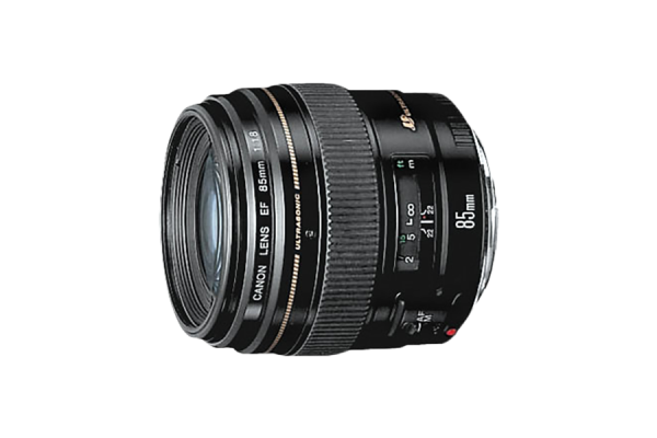A black, cylindrical DSLR camera lens that has "85mm" printed on the barrel. It has a focus ring. Its height is slightly more than its width and depth.