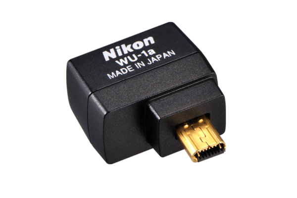 A tiny Nikon camera wireless adaptor in black, one that plugs into a Nikon camera.