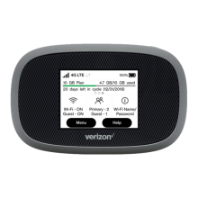 A black, pocket-sized, Verizon-branded mobile hotspot with its screen on, showing signal strength.