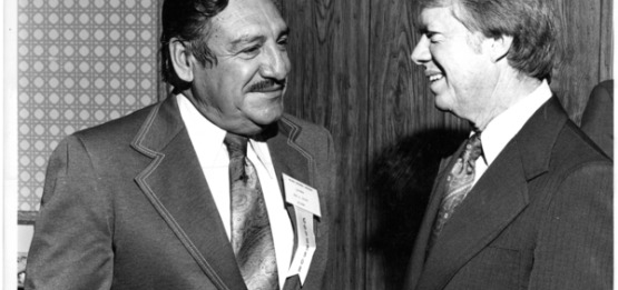 Black & white photo of Governor Castro with President Jimmy Carter, the two men are smiling at one another